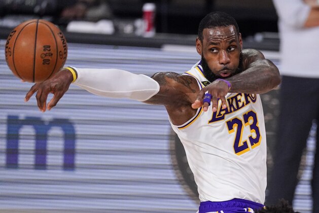 Los Angeles Lakers' LeBron James (23) passes the ball against Miami Heat during the first half in Game 3 of basketball's NBA Finals, Sunday, Oct. 4, 2020, in Lake Buena Vista, Fla. (AP Photo/Mark J. Terrill)