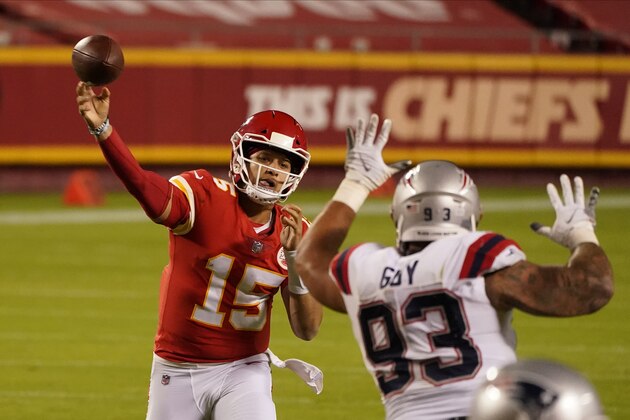 Kansas City Chiefs quarterback Patrick Mahomes (15) throws as New England Patriots defensive tackle Lawrence Guy (93) applies pressure during the second half of an NFL football game, Monday, Oct. 5, 2020, in Kansas City. (AP Photo/Charlie Riedel)