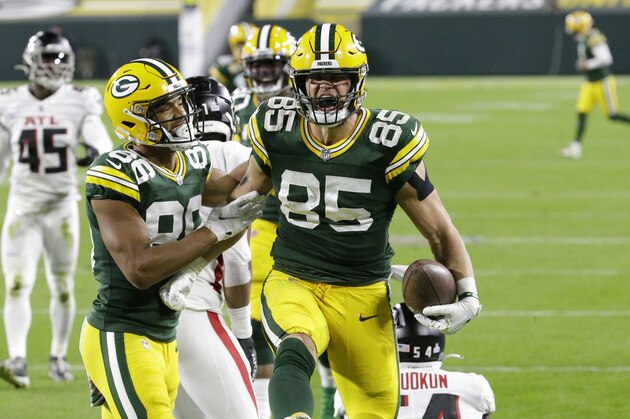 Green Bay Packers' Robert Tonyan (85) celebrates a touchdown reception with Malik Taylor (86) during the first half of an NFL football game against the Atlanta Falcons, Monday, Oct. 5, 2020, in Green Bay, Wis. (AP Photo/Mike Roemer)
