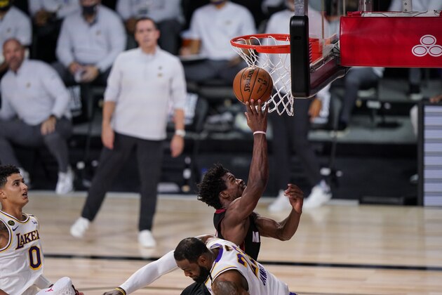 Miami Heat's Jimmy Butler (22) shoots against Los Angeles Lakers' LeBron James (23) during the second half in Game 3 of basketball's NBA Finals, Sunday, Oct. 4, 2020, in Lake Buena Vista, Fla. (AP Photo/Mark J. Terrill)