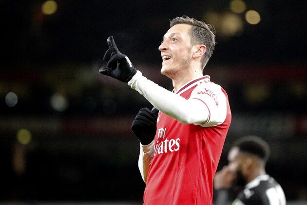 Arsenal's Mesut Ozil celebrates after scoring his side's third goal during the English Premier League soccer match between Arsenal and Newcastle at the Emirates Stadium in London, Sunday, Feb. 16, 2020.(AP Photo/Frank Augstein)