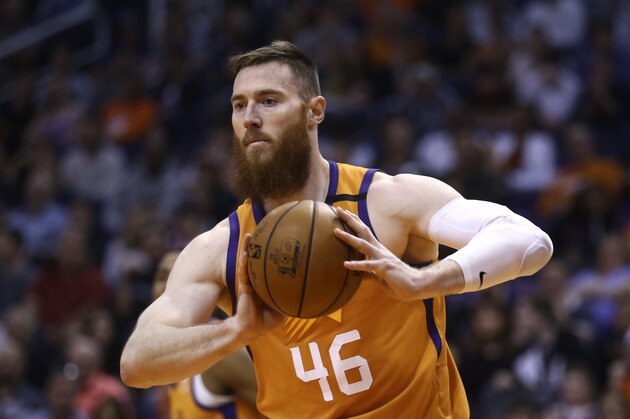 Phoenix Suns center Aron Baynes grabs a rebound against the Portland Trail Blazers during the first half of an NBA basketball game Friday, March 6, 2020, in Phoenix. The Suns defeated the Trail Blazers 127-117. (AP Photo/Ross D. Franklin)