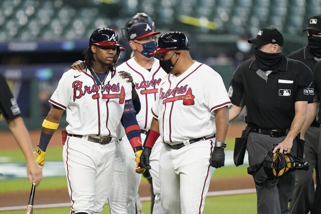 Atlanta Braves' Ronald Acuna Jr., left, is walked to first base after he was hit by a pitch during the third inning in Game 1 of a baseball National League Division Series against the Miami Marlins Tuesday, Oct. 6, 2020, in Houston. (AP Photo/Eric Gay) Atlanta Braves' Ronald Acuna Jr., left, is walked to first base after he was hit by a pitch during the third inning in Game 1 of a baseball National League Division Series against the Miami Marlins Tuesday, Oct. 6, 2020, in Houston. (AP Photo/Eric Gay)