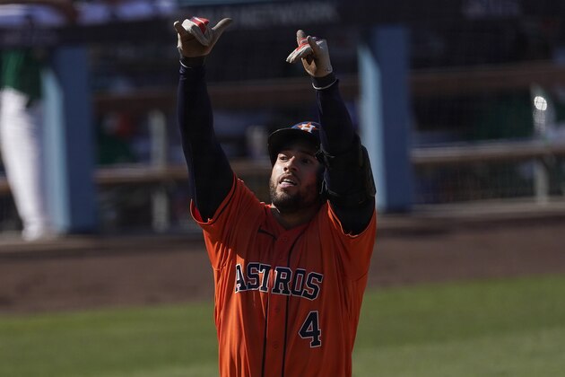 Houston Astros' George Springer celebrates after hitting a solo home run off of Oakland Athletics relief pitcher Yusmeiro Petit during the fifth inning of Game 2 of a baseball American League Division Series in Los Angeles, Tuesday, Oct. 6, 2020. (AP Photo/Ashley Landis)