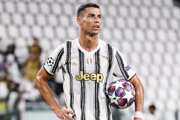 Juventus' Cristiano Ronaldo holds the ball during the Champions League round of 16 second leg, soccer match between Juventus and Lyon at the Allianz stadium in Turin, Italy, Friday, Aug. 7, 2020. (Marco Alpozzi/LaPresse via AP)