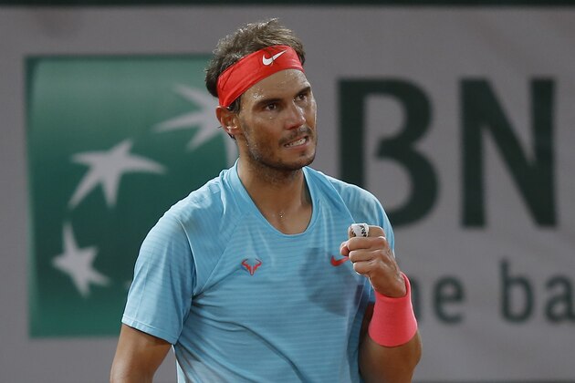 Spain's Rafael Nadal clenches his fist after winning the first set against Italy's Jannik Sinner in the quarterfinal match of the French Open tennis tournament at the Roland Garros stadium in Paris, France, Tuesday, Oct. 6, 2020. (AP Photo/Michel Euler)