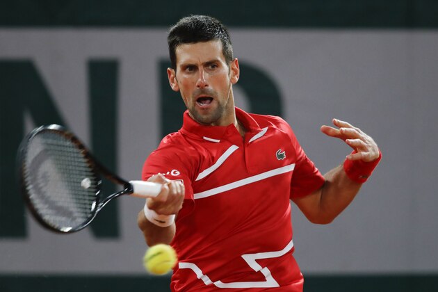 Serbia's Novak Djokovic plays a shot against Russia's Karen Khachanov in the fourth round match of the French Open tennis tournament at the Roland Garros stadium in Paris, France, Monday, Oct. 5, 2020. (AP Photo/Christophe Ena) Serbia's Novak Djokovic plays a shot against Russia's Karen Khachanov in the fourth round match of the French Open tennis tournament at the Roland Garros stadium in Paris, France, Monday, Oct. 5, 2020. (AP Photo/Christophe Ena)