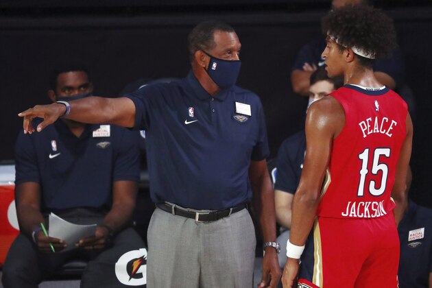 New Orleans Pelicans head coach Alvin Gentry, left, talks with guard Frank Jackson (15) during the first half of an NBA basketball game against the Orlando Magic, Thursday, Aug. 13, 2020, in Lake Buena Vista, Fla. (Kim Klement/Pool Photo via AP)