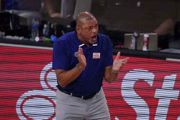 Los Angeles Clippers head coach Doc Rivers reacts on the bench during the first half of an NBA conference semifinal playoff basketball game against the Denver Nuggets Saturday, Sept. 5, 2020, in Lake Buena Vista, Fla. (AP Photo/Mark J. Terrill) Los Angeles Clippers head coach Doc Rivers reacts on the bench during the first half of an NBA conference semifinal playoff basketball game against the Denver Nuggets Saturday, Sept. 5, 2020, in Lake Buena Vista, Fla. (AP Photo/Mark J. Terrill)