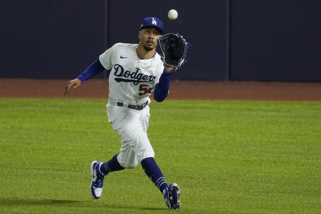 Los Angeles Dodgers right fielder Mookie Betts (50) catches a flyout hit by San Diego Padres' Tommy Pham during the ninth inning in Game 1 of a baseball NL Division Series, Wednesday, Oct. 7, 2020, in Arlington, Texas. (AP Photo/Tony Gutierrez)