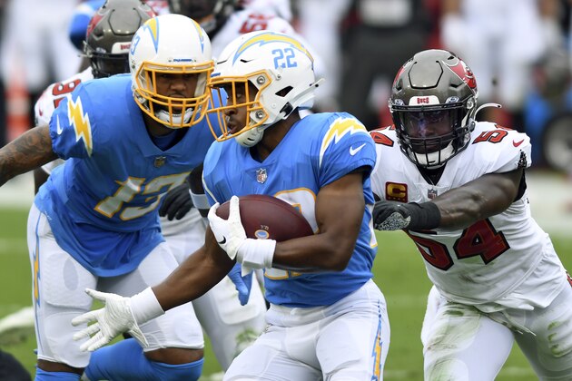 Los Angeles Chargers running back Justin Jackson (22) runs away from Tampa Bay Buccaneers inside linebacker Lavonte David (54) during the first half of an NFL football game Sunday, Oct. 4, 2020, in Tampa, Fla. (AP Photo/Jason Behnken) Los Angeles Chargers running back Justin Jackson (22) runs away from Tampa Bay Buccaneers inside linebacker Lavonte David (54) during the first half of an NFL football game Sunday, Oct. 4, 2020, in Tampa, Fla. (AP Photo/Jason Behnken)