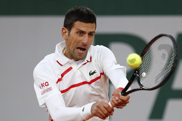 Serbia's Novak Djokovic plays a shot against Spain's Pablo Carreno Busta in the quarterfinal match of the French Open tennis tournament at the Roland Garros stadium in Paris, France, Wednesday, Oct. 7, 2020. (AP Photo/Christophe Ena) Serbia's Novak Djokovic plays a shot against Spain's Pablo Carreno Busta in the quarterfinal match of the French Open tennis tournament at the Roland Garros stadium in Paris, France, Wednesday, Oct. 7, 2020. (AP Photo/Christophe Ena)