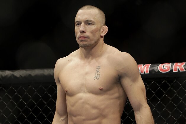 Georges St. Pierre, of Canada, waits to begin a UFC 167 mixed martial arts championship welterweight bout against Johny Hendricks on Saturday, Nov. 16, 2013, in Las Vegas. St. Pierre won by split decision. (AP Photo/Isaac Brekken)