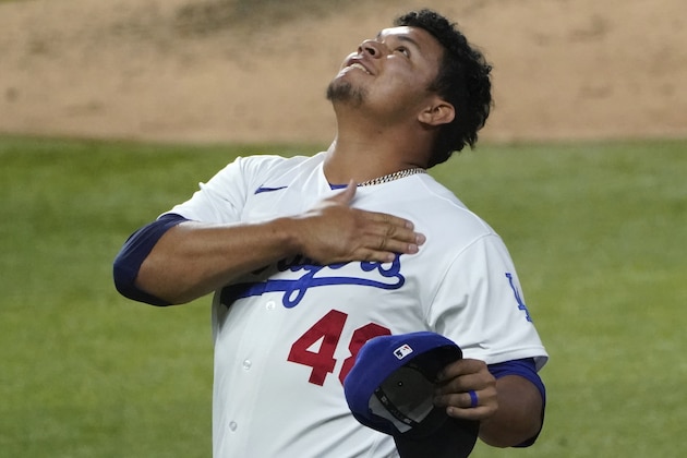 Los Angeles Dodgers relief pitcher Brusdar Graterol celebrates after a catch by Cody Bellinger ended the top of the seventh inning in Game 2 of a baseball National League Division Series Wednesday, Oct. 7, 2020, in Arlington, Texas. (AP Photo/Sue Ogrocki)