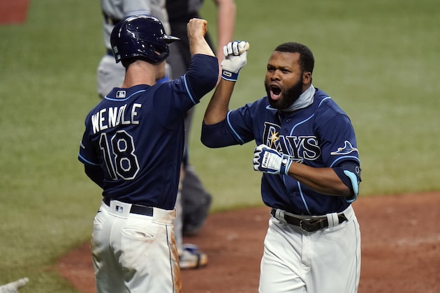 Tampa Bay Rays' Manuel Margot celebrates his two-run home run off Toronto Blue Jays relief pitcher A.J. Cole with Joey Wendle (18) during the seventh inning of Game 1 of a wild card series playoff baseball game Tuesday, Sept. 29, 2020, in St. Petersburg, Fla. (AP Photo/Chris O'Meara) Tampa Bay Rays' Manuel Margot celebrates his two-run home run off Toronto Blue Jays relief pitcher A.J. Cole with Joey Wendle (18) during the seventh inning of Game 1 of a wild card series playoff baseball game Tuesday, Sept. 29, 2020, in St. Petersburg, Fla. (AP Photo/Chris O'Meara)