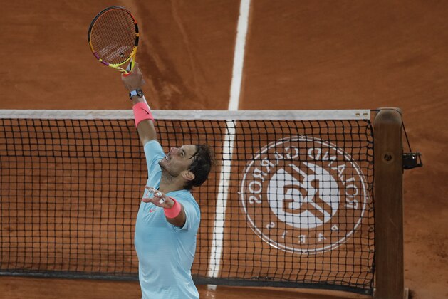 Spain's Rafael Nadal celebrates winning his quarterfinal match of the French Open tennis tournament against Italy's Jannik Sinner in three sets, 7-6 (7-4), 6-4, 6-1, at the Roland Garros stadium in Paris, France, Wednesday, Oct. 7, 2020. (AP Photo/Alessandra Tarantino)