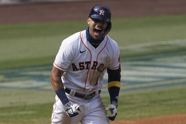 Houston Astros' Carlos Correa celebrates after hitting a three-run home run against the Oakland Athletics during the fourth inning of Game 4 of a baseball American League Division Series in Los Angeles, Thursday, Oct. 8, 2020. (AP Photo/Ashley Landis)