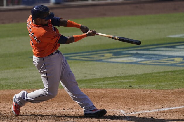 Houston Astros' Martin Maldonado swings on a solo home run against the Oakland Athletics during the fifth inning of Game 2 of a baseball American League Division Series in Los Angeles, Tuesday, Oct. 6, 2020. (AP Photo/Ashley Landis)