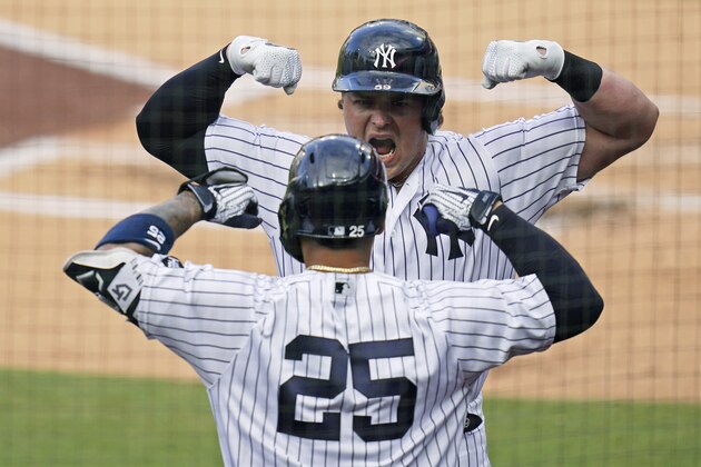 New York Yankees' Luke Voit, right, celebrates with Gleyber Torres (25) after Voit hit a solo home run against the Tampa Bay Rays during the second inning in Game 4 of a baseball American League Division Series against the Tampa Bay Rays, Thursday, Oct. 8, 2020, in San Diego. (AP Photo/Gregory Bull)