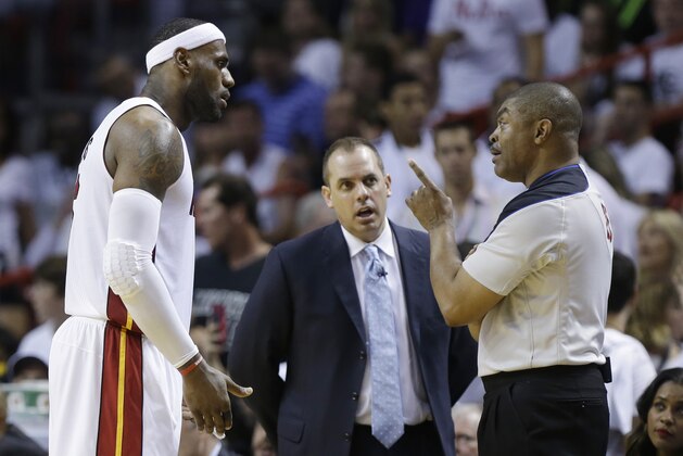 Miami Heat forward LeBron James (6) and Indiana Pacers head coach Frank Vogel listen to official Tony Brothers during the second half of Game 3 in the NBA basketball Eastern Conference finals playoff series, Saturday, May 24, 2014, in Miami. (AP Photo/Lynne Sladky)