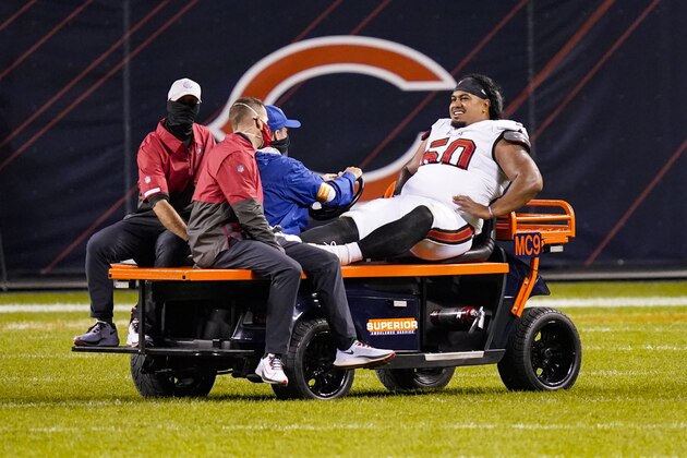 Tampa Bay Buccaneers nose tackle Vita Vea (50) is driven off the field after being injured in the second half of an NFL football game against the Chicago Bears in Chicago, Thursday, Oct. 8, 2020. (AP Photo/Charles Rex Arbogast)