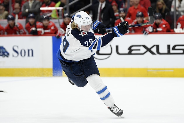 Winnipeg Jets right wing Patrik Laine (29), of Finland, follows through on a shot during the first period of an NHL hockey game against the Washington Capitals, Tuesday, Feb. 25, 2020, in Washington. (AP Photo/Nick Wass)