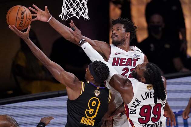 Los Angeles Lakers guard Rajon Rondo (9) shoots over Miami Heat forward Jae Crowder and forward Jimmy Butler during the first half in Game 5 of basketball's NBA Finals Friday, Oct. 9, 2020, in Lake Buena Vista, Fla. (AP Photo/Mark J. Terrill)