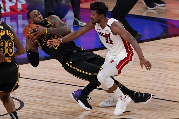 Los Angeles Lakers forward LeBron James pulls rebound away from Miami Heat forward Jimmy Butler during the second half in Game 5 of basketball's NBA Finals Friday, Oct. 9, 2020, in Lake Buena Vista, Fla. (AP Photo/Mark J. Terrill) Los Angeles Lakers forward LeBron James pulls rebound away from Miami Heat forward Jimmy Butler during the second half in Game 5 of basketball's NBA Finals Friday, Oct. 9, 2020, in Lake Buena Vista, Fla. (AP Photo/Mark J. Terrill)