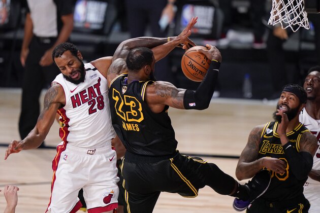 Miami Heat guard Andre Iguodala vies for a rebound with Los Angeles Lakers forward LeBron James during the first half in Game 5 of basketball's NBA Finals Friday, Oct. 9, 2020, in Lake Buena Vista, Fla. (AP Photo/Mark J. Terrill)
