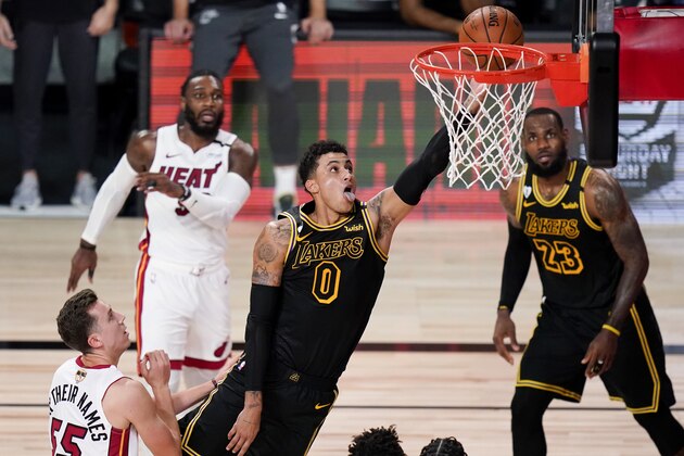 Los Angeles Lakers forward Kyle Kuzma scores past Miami Heat guard Duncan Robinson during the second half in Game 5 of basketball's NBA Finals Friday, Oct. 9, 2020, in Lake Buena Vista, Fla. (AP Photo/John Raoux)