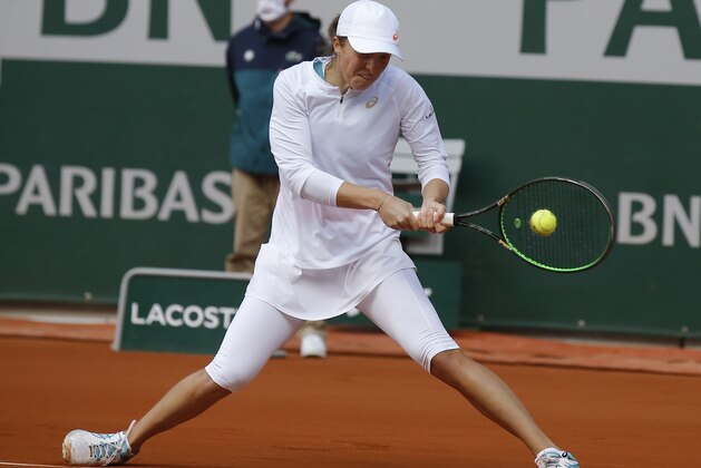 Poland's Iga Swiatek plays a shot against Sofia Kenin of the U.S. in the final match of the French Open tennis tournament at the Roland Garros stadium in Paris, France, Saturday, Oct. 10, 2020. (AP Photo/Michel Euler)