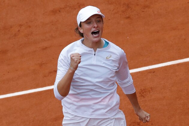Poland's Iga Swiatek celebrates winning the final match of the French Open tennis tournament against Sofia Kenin of the U.S. in two sets, 6-4, 6-1, at the Roland Garros stadium in Paris, France, Saturday, Oct. 10, 2020. (AP Photo/Christophe Ena)