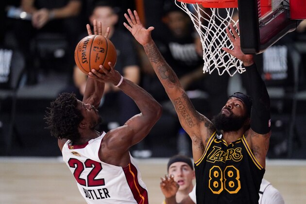 Miami Heat forward Jimmy Butler, left, shoots over Los Angeles Lakers forward Markieff Morris during the first half in Game 5 of basketball's NBA Finals Friday, Oct. 9, 2020, in Lake Buena Vista, Fla. (AP Photo/Mark J. Terrill)