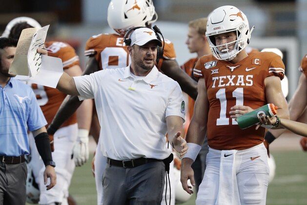 Texas head coach Tom Herman, left, and Texas quarterback Sam Ehlinger (11) during the first half of an NCAA college football game against Oklahoma State Saturday, Sept. 21, 2019, in Austin, Texas. (AP Photo/Eric Gay)