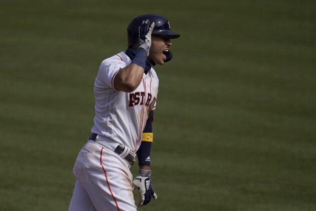 Houston Astros' Carlos Correa reacts while rounding the bases on his three-run home run against the Oakland Athletics during the fourth inning of Game 4 of a baseball American League Division Series in Los Angeles, Thursday, Oct. 8, 2020. (AP Photo/Marcio Jose Sanchez)