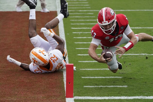 Georgia quarterback Stetson Bennett (13) dives past Tennessee defensive back Jaylen McCollough (22) to score a touchdown in the first half of an NCAA college football game Saturday, Oct. 10, 2020, in Athens, Ga. (AP Photo/John Bazemore) Georgia quarterback Stetson Bennett (13) dives past Tennessee defensive back Jaylen McCollough (22) to score a touchdown in the first half of an NCAA college football game Saturday, Oct. 10, 2020, in Athens, Ga. (AP Photo/John Bazemore)