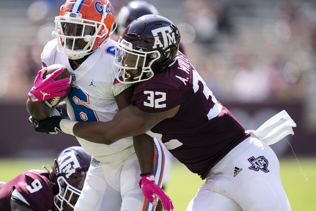Florida running back Nay'Quan Wright (6) is wrapped up by Texas A&M linebacker Andre White Jr. (32) during the first half of an NCAA college football game, Saturday, Oct. 10, 2020. in College Station, Texas. (AP Photo/Sam Craft)