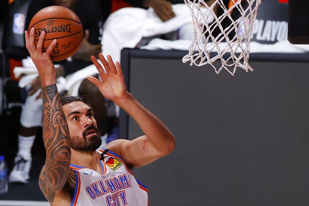 Oklahoma City Thunder's Steven Adams , left, goes up to dunk over Houston Rockets' Robert Covington during the first half in Game 2 of an NBA basketball first-round playoff series, Thursday, Aug. 20, 2020, in Lake Buena Vista, Fla. (Kevin C. Cox/Pool Photo via AP)
