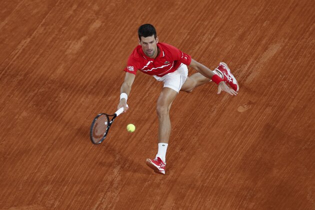 Serbia's Novak Djokovic plays a shot against Greece's Stefanos Tsitsipas in the semifinal match of the French Open tennis tournament at the Roland Garros stadium in Paris, France, Friday, Oct. 9, 2020. (AP Photo/Alessandra Tarantino)
