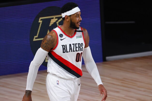 Portland Trail Blazers' Carmelo Anthony reacts after being charged with an offensive foul against the Los Angeles Lakers in Game 4 of an NBA basketball first-round playoff series, Monday, Aug. 24, 2020, in Lake Buena Vista, Fla. (Kevin C. Cox/Pool Photo via AP)