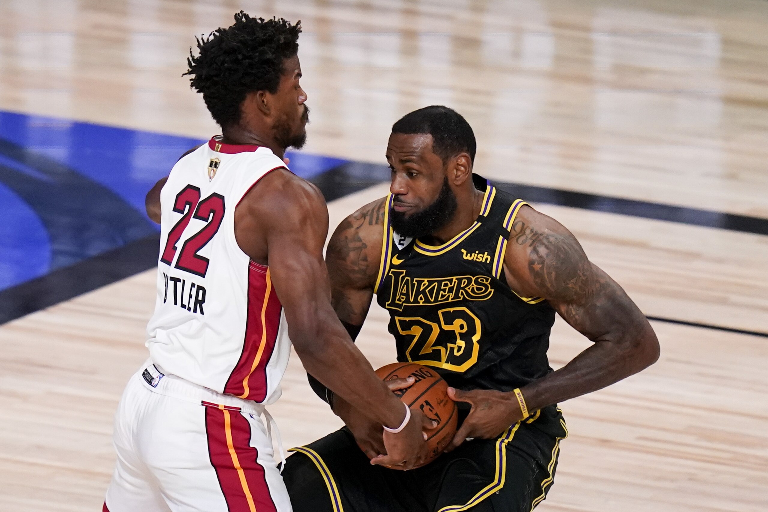 Miami Heat forward Jimmy Butler, left, guards Los Angeles Lakers forward LeBron James during the first half in Game 5 of basketball's NBA Finals Friday, Oct. 9, 2020, in Lake Buena Vista, Fla. (AP Photo/John Raoux)