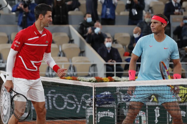 Serbia's Novak Djokovic, left, and Spain's Rafael Nadal look at each other as they pose for images prior to the final match of the French Open tennis tournament at the Roland Garros stadium in Paris, France, Sunday, Oct. 11, 2020. (AP Photo/Michel Euler)