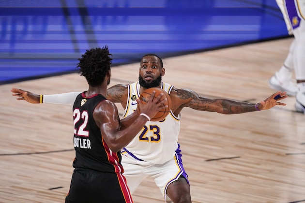 Los Angeles Lakers' LeBron James (23) attempt to block Miami Heat's Jimmy Butler (22) during the first half in Game 3 of basketball's NBA Finals, Sunday, Oct. 4, 2020, in Lake Buena Vista, Fla. (AP Photo/Mark J. Terrill)