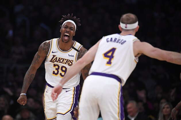 Los Angeles Lakers center Dwight Howard, left, celebrates after scoring as guard Alex Caruso, left, watches during the second half of an NBA basketball game against the Detroit Pistons Sunday, Jan. 5, 2020, in Los Angeles. The Lakers won 106-99. (AP Photo/Mark J. Terrill)