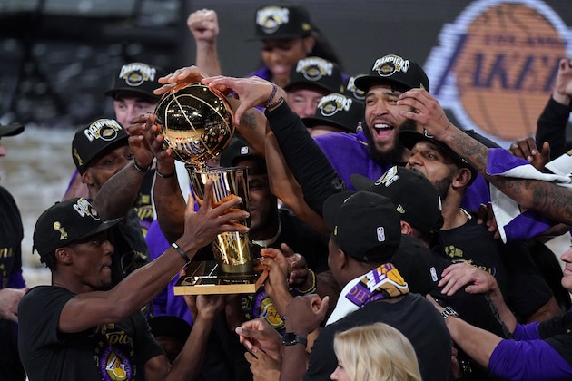 The Los Angeles Lakers players celebrate after the Lakers defeated the Miami Heat 103-88 in Game 6 of basketball's NBA Finals Sunday, Oct. 11, 2020, in Lake Buena Vista, Fla. (AP Photo/Mark J. Terrill)