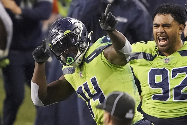 Seattle Seahawks' Bryan Mone (92) cheers on DK Metcalf (14) after Metcalf pulled in a long pass near the end of the second half of an NFL football game against the Minnesota Vikings, Sunday, Oct. 11, 2020, in Seattle. The Seahawks won 27-26. (AP Photo/Ted S. Warren)