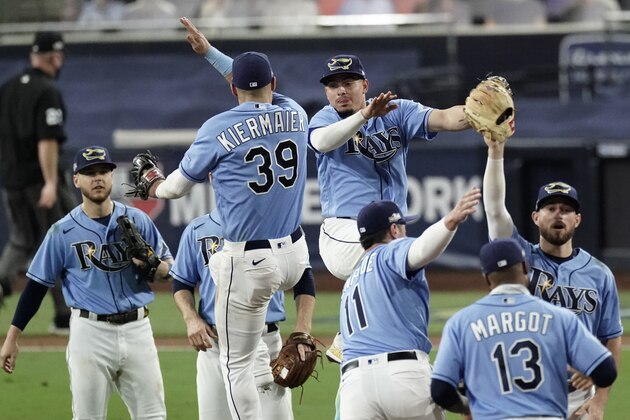 Tampa Bay Rays celebrate their 2-1 victory over the Houston Astros in Game 1 of a baseball American League Championship Series, Sunday, Oct. 11, 2020, in San Diego. The Rays lead the series 1-0 games. (AP Photo/Jae C. Hong)