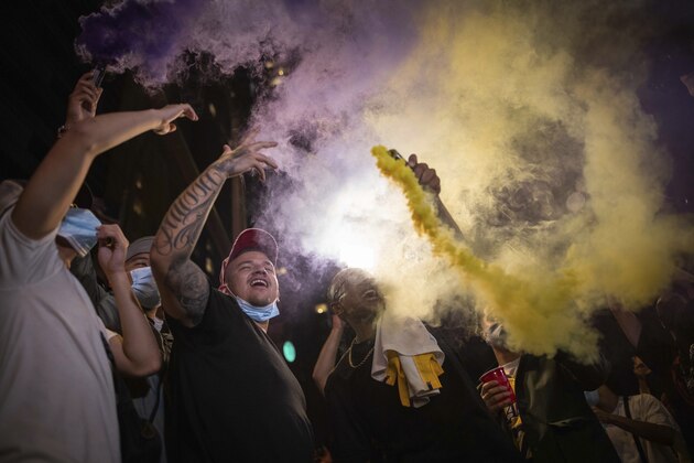 Lakers fans celebrate outside of Staples center Sunday, Oct. 11, 2020, in Los Angeles, Calif, after the Lakers defeated the Miami Heat in Game 6 of basketball's NBA Finals to win the championship. (AP Photo/Christian Monterrosa)