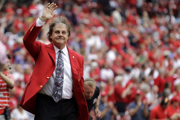 Former St. Louis Cardinals manager waves during a ceremony before the start of a baseball game between the St. Louis Cardinals and the Milwaukee Brewers  Monday, April 13, 2015, in St. Louis. (AP Photo/Jeff Roberson)
