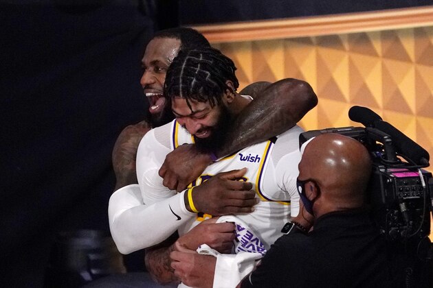 Los Angeles Lakers' LeBron James (23) and Anthony Davis (3) celebrate after the Lakers defeated the Miami Heat 106-93 in Game 6 of basketball's NBA Finals Sunday, Oct. 11, 2020, in Lake Buena Vista, Fla. (AP Photo/Mark J. Terrill)